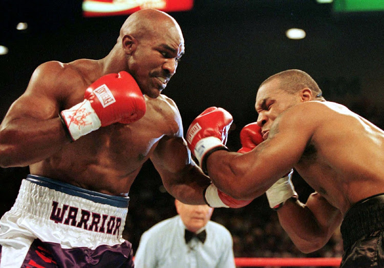 WBA Heavyweight Champion Evander Holyfield (right) connects to the jaw of challenger Mike Tyson in the first round of their title fight June 28, 1997.