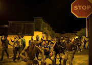 African migrants react after crossing the border from Morocco to Spain's North African enclave of Ceuta, Spain, early August 1, 2017. 