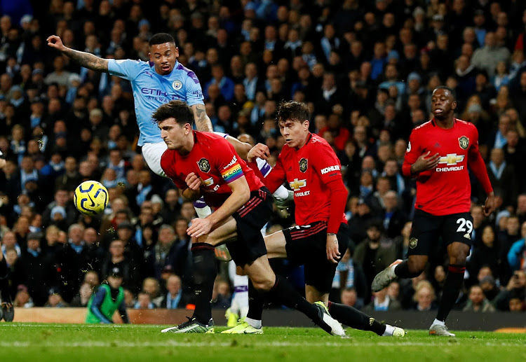 Manchester United's Harry Maguire and Victor Lindelof in action with Manchester City's Gabriel Jesus