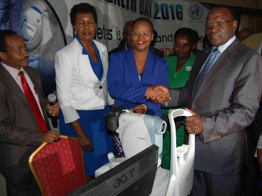 Health Cabinet Secretary Cleopa Mailu hands over a diabetes retinopathy fundoscope machine worth Sh3.8 million to Kenyatta National Hospital CEO Lily Koros during the commemoration of World Health Day at Silver Springs Hotel in Nairobi, April, 7, 2016. Photo/EMMANUEL WANJALA