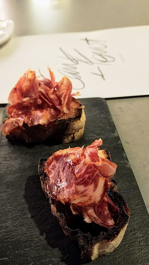 Can Font Happy Hour includes various Montaditos, a tapas of bread mounted with various ingredients. This is the Montadito de Llom with grilled Catalan bread, tomatoes, Iberico cured loin