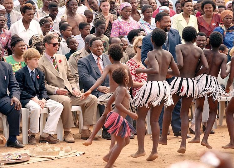 Prince Harry and Prince Charles watch a traditional Zulu dance during their official visit to South Africa in 1997.