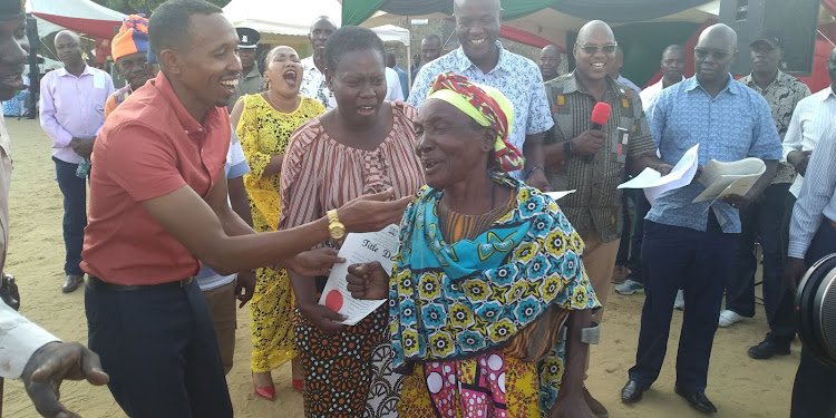 Elated Sidi Kenga cannot hide her joy as she received her title deed from Lands CS Farida Karoney and Nyali MP Mohammed Ali at Frere Town ground on Saturday.