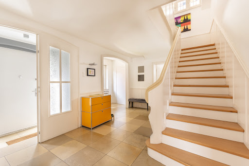 entrance with staircase and orange cabinet in this luxury property for sale in Essen ($1,141,479 - 178 m²)