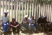 Unemployed men wait for work in Soweto. File photo.