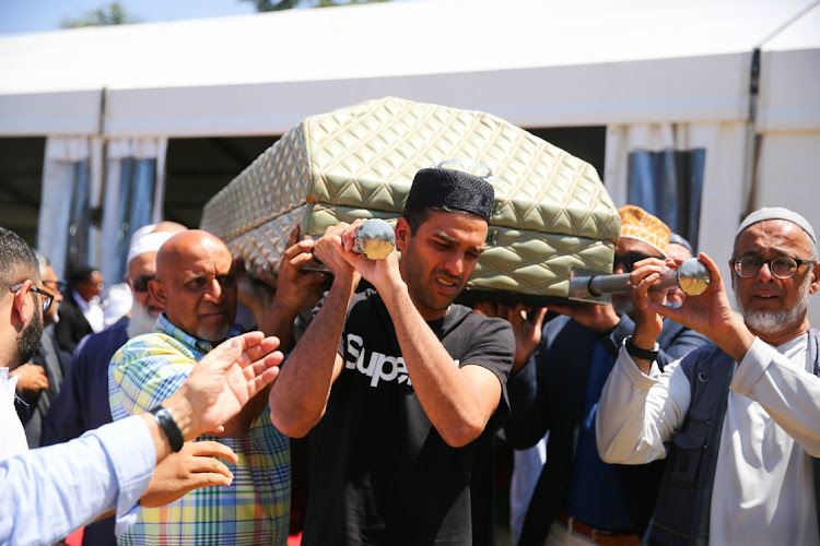 Family members carry the coffin of anti-apartheid struggle stalwart and former foreign affairs deputy minister Aziz Pahad during his state funeral at Westpark Cemetery in Johannesburg on September 30 2023.