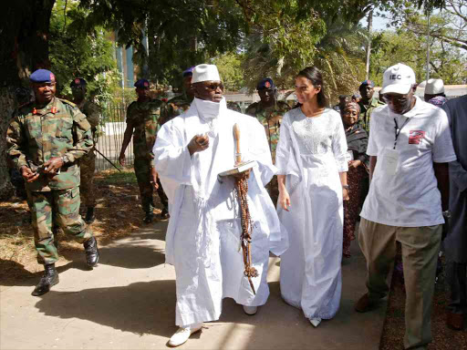 Gambian President Yahya Jammeh leaves a polling station with his wife Zineb during the presidential election in Banjul, Gambia, December 1, 2016. /REUTERS