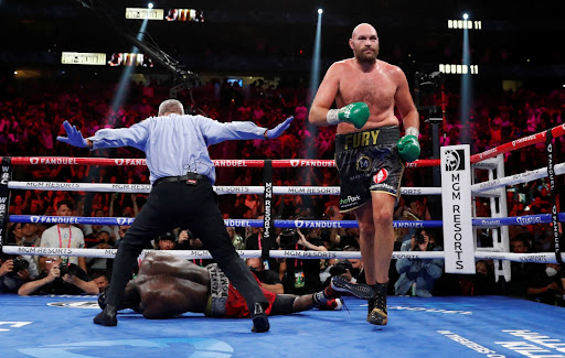 Tyson Fury knocks down Deontay Wilder in the WBC heavyweight title clash at T-Mobile Arena, Las Vegas, Nevada on October 9, 2021.