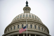 The American flag flies at half staff at the US Capitol Building on the fifth day of the impeachment trial of former US President Donald Trump, on charges of inciting the deadly attack on the US Capitol, in Washington, on February 13 2021. 