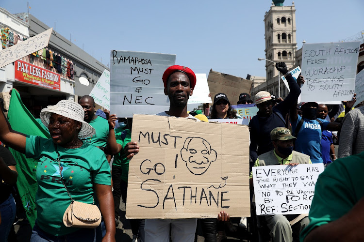 A protester holds up his placard during a protest march in Durban on Monday in opposition to government violating people's freedom of choice