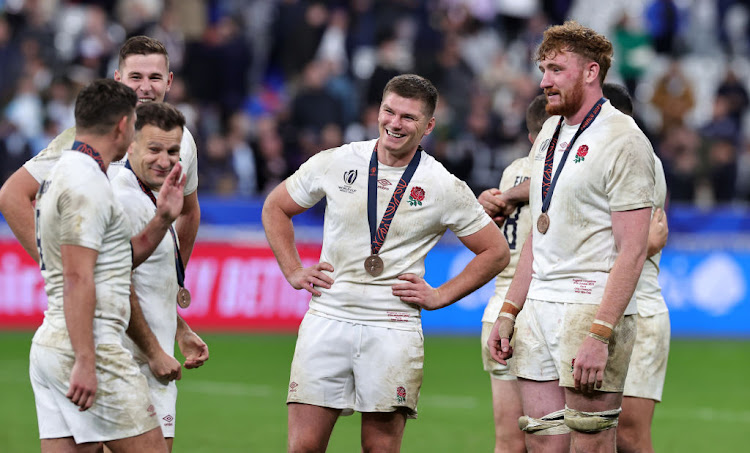 England captain Owen Farrell, (C), celebrates with team mates after their 2023 Rugby World Cup bronze medal win over Argentina at the Stade de France.