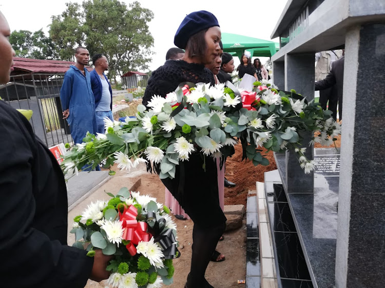 Murdered Collins Khosa's wife Nomsa Montsha pays her last respects at his grave in Mawa village outside Tzaneen on Saturday.