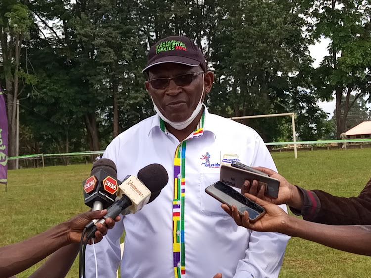 Athletics Kenya 's central region chair David Miano speaks to the media on Saturday during the region's cross country competition at the Kerugoya stadium