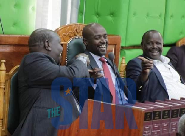 Governor Hillary Barchok (center) shares some light moments with his rivals Joh Mosonik (left) and Isaac Rutto at the Bomet county assembly chambers on Tuesday.