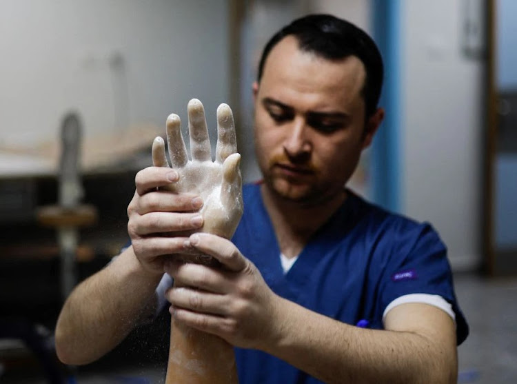 A Palestinian technician prepares a myoelectric limb at the Sheikh Hamad Bin Khalifa Al Thani Rehabilitation and Prosthetics Hospital in the northern Gaza Strip April 13, 2022. Picture taken April 13, 2022