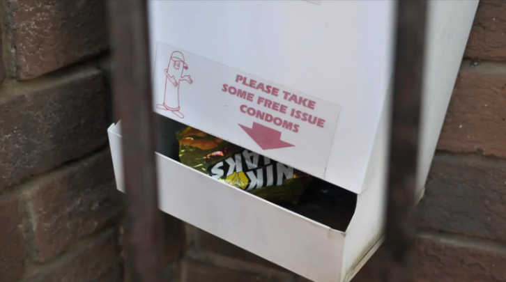 An empty condom dispenser seen with a Nik Naks wrapper inside at one of the clinics monitored by Ritshidze.