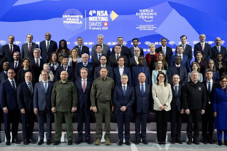 Participants pose for a group picture, with Borge Brende, president WEF, Andriy Yermak, head of the Ukrainian president's office, Swiss federal councillor Ignazio Cassis, Klaus Schwab, WEF founder and Yulia Svyrydenko, first deputy prime minister of Ukraine, in the front row, during the fourth meeting of the national security advisers on a peace formula for Ukraine, in Davos, Switzerland, January 14 2024. Picture: HANDOUT/REUTERS