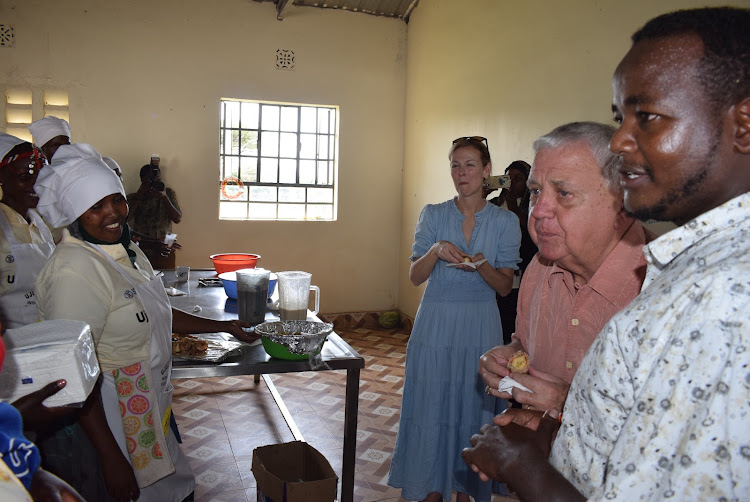 Officials taste some of the foods prepared by some of the beneficiaries of Ujuzi Manyattani