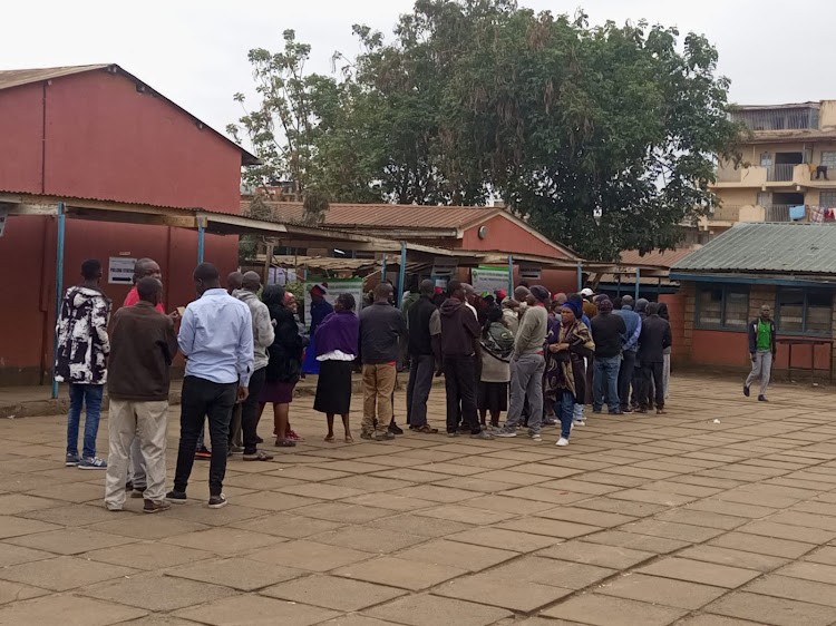 Voters queue at Mwangaza Primary school in Kayole/MAGDALINE SAYA