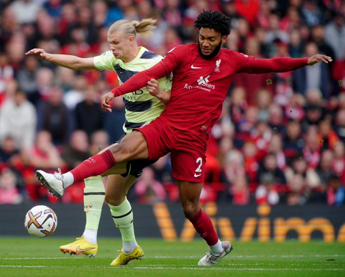 Manchester City's Erling Haaland in action with Liverpool defender Joe Gomez