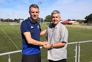 Ajax Cape Town chief executive Ari Efstathiou (R) presents the new Urban Warriors head coach Andries Ulderink (L) on November 29 2018. 