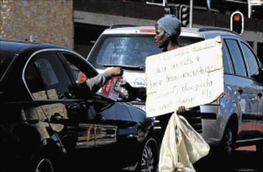 MAKING A LIVING: It is a common sight to see people begging on the streets of Gauteng Photo: Tsheko Kabasia