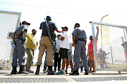 Police officers speak to protesters.