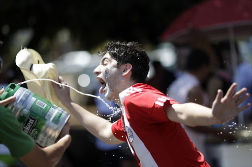 A man tries to drink beer during the Race of Beer in Brasilia August 28, 2011. Participants of the annual race run a 2km (1.2 mile) route while drinking beer along the way and the person with most amount of beer consumed at the finishing line is the winner