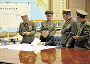 This official photo shows North Korea's Kim Jong-un in an emergency meeting with top officers