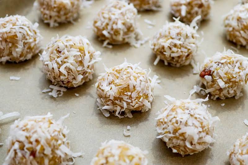 Dough Rolled Into A Ball And Rolled In Shredded Coconut.