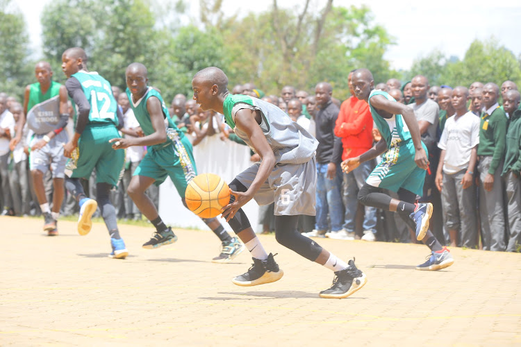 Birone Otieno dribbles the ball during the basketball final against Nyanchwa