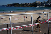 A beachgoer in bathing suit and protective face mask walks up the promenade at Bondi Beach during a lockdown to curb the spread of a coronavirus disease (Covid-19) outbreak in Sydney, Australia, September 1, 2021. 