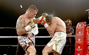 Kevin Lerena lands a punch on Artur Mann of Germany  during his IBO cruiserweight title defence at Emperor's Palace.