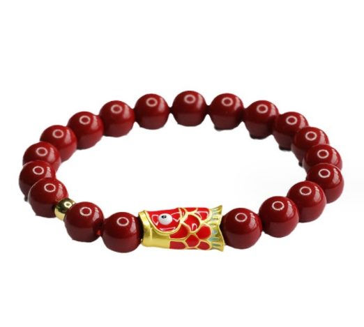 Chaîne de main sable rouge et bracelet carpe sable or violet. Un accessoire unique pour la chance et l'élégance.