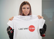 Belarusian sprinter Krystsina Tsimanouskaya, who left the Olympic Games in Tokyo and seeks asylum in Poland, holds a T-shirt at a news conference in Warsaw, Poland, on August 5 2021. 