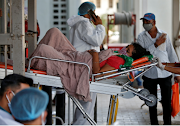 A patient is wheeled inside a Covid-19 hospital for treatment, amidst the spread of the coronavirus disease in Ahmedabad, India, on April 19 2021.
