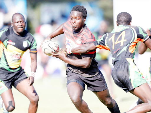 NO YOU DON’T: Nato Simiyu (C) of Impala challenges Larry Safari of Topfry Nakuru during their Kenya Cup match at Impala grounds in Nairobi on Saturday. The Nairobi Ngong Road club fought out a 28-15 victory.