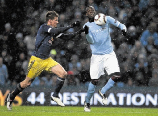 SUPER MARIO: Manchester City striker Mario Balotelli, right, fights for the ball with FC Salzburg's Franz Schiemer during their Uefa Europa League match. Balotelli is expected to lead City against Villarreal in their Champions League clash tonight. Photo: Getty Images