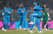 Ravi Jadeja of India celebrates the wicket of South African captain Temba Bavuma with teammate Virat Kohli during their 2023 Cricket World Cup match at Eden Gardens on November 05, 2023 in Kolkata, India. 