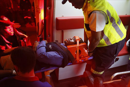 Medical services attend to injured passengers at the Lynn Ross Train station on Monday night. Picture: Phill Magakoe