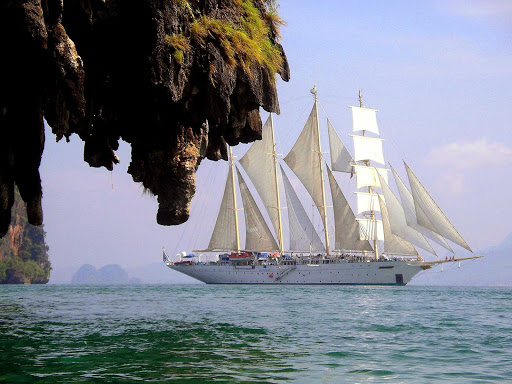 The Star Clipper sails in a gorgeous bay in Thailand.