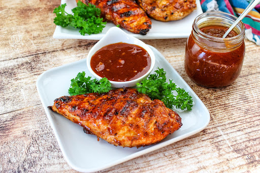 Grilled chicken breasts with Apricot Barbecue Sauce.