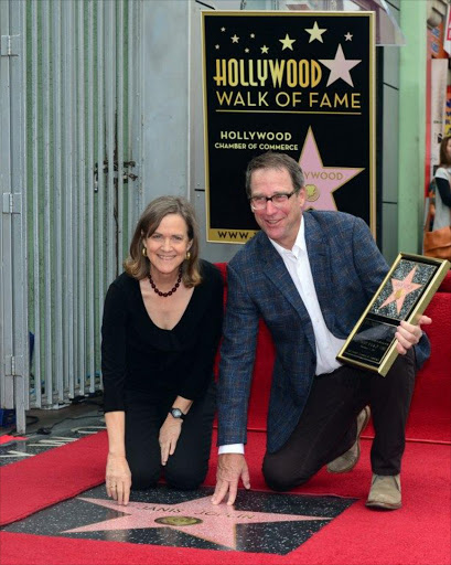 Siblings of the late Janis Joplin, Laura (L) and Michael (R), pose beside the Janis Joplin star,during a ceremony on November 4, 2013 in Hollywood, California.