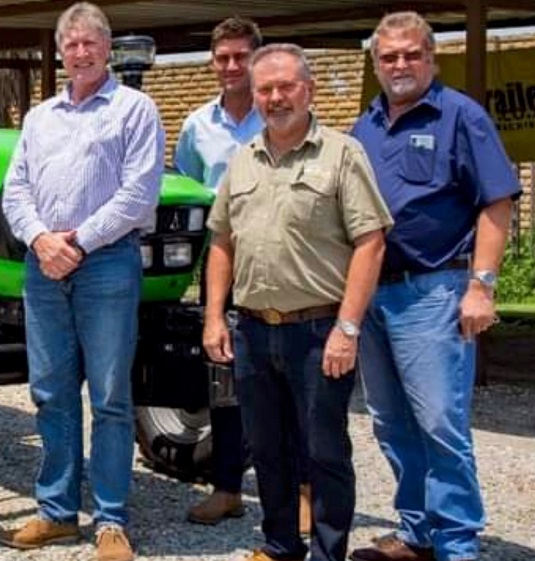 Kempston Agri GM Dick David (blue long-sleeve shirt) and Chris Diedericks (short-sleeve navy shirt) with two unidentified men.