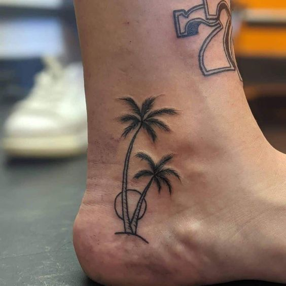 Full view of a palm tree tattoo.