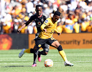 Mduduzi Shabalala of Kaizer Chiefs is challenged by Innocent Maela of Orlando Pirates in the DStv Premiership Soweto derby match at FNB Stadium on February 25 2022.