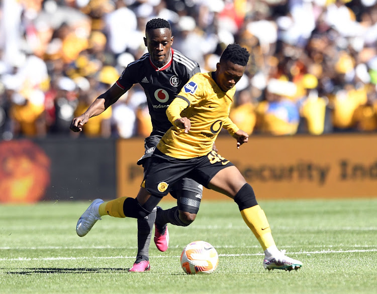 Mduduzi Shabalala of Kaizer Chiefs is challenged by Innocent Maela of Orlando Pirates in the DStv Premiership Soweto derby match at FNB Stadium on February 25 2022.