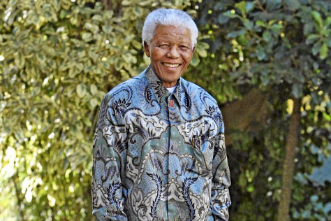 Nelson Mandela in one of his trademark Madiba shirts. The man who has the key to the cell in which Mandela was locked during his incarceration on Robben Island wants an auction house to withdraw the key from the auction.