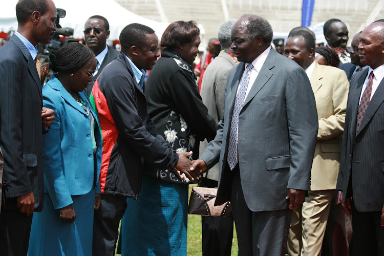 Hussein Ibrahim shakes hands with former President, the late Mwai Kibaki