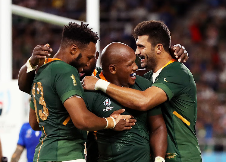 Mbongeni Mbonambi celebrates with teammates after scoring the Springbok's second try during the Rugby World Cup 2019 Group B game between South Africa and Italy.